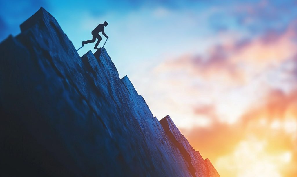 An image showing a person climbing a graph chart that keeps ascending to represent financial success and goal achievement